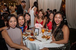 studnets pose at a table during the Eyeball 2016 party