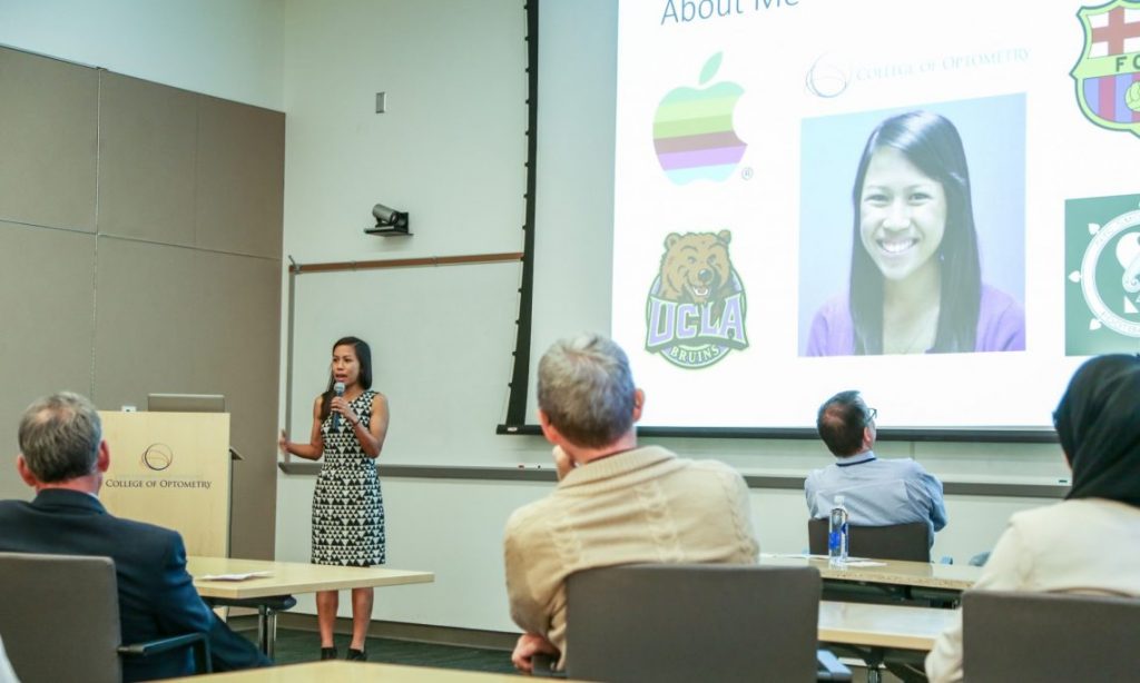 Student speaks to people during presentation