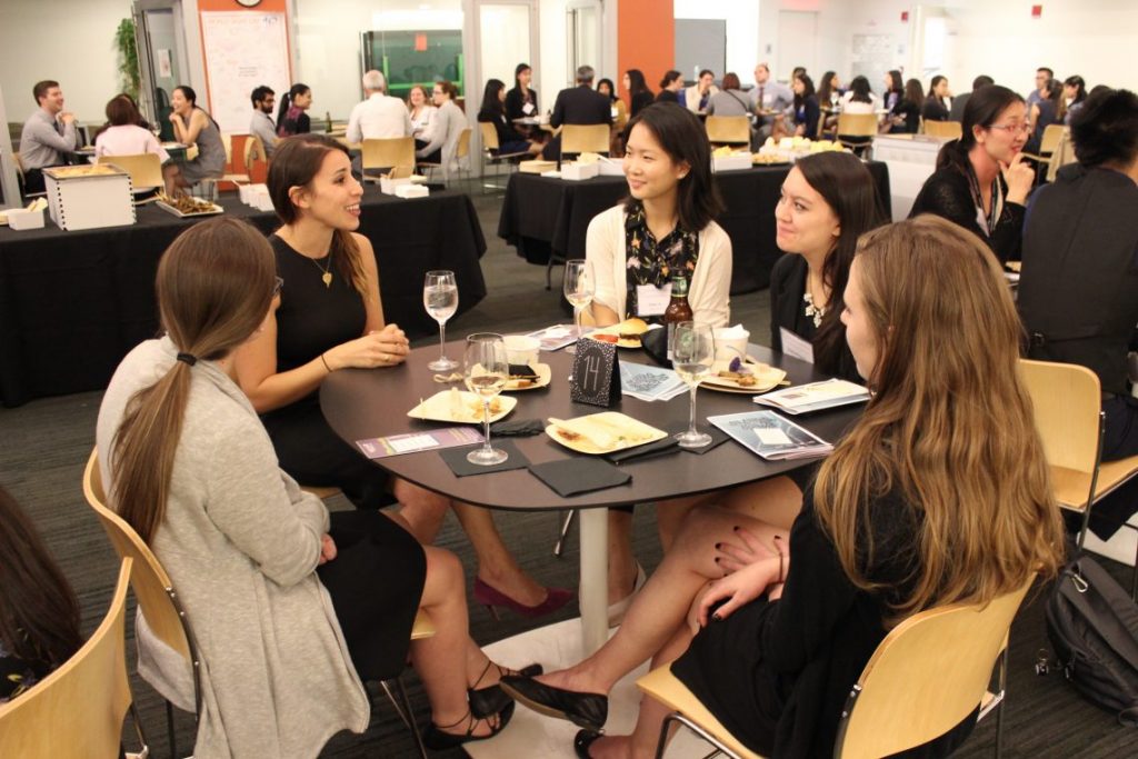 Students talking at table at networking event