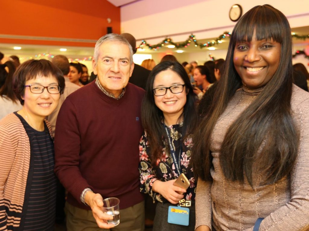 Faculty and staff pose at Optometry Holiday party