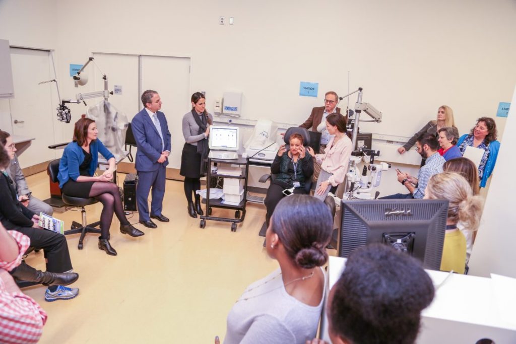 patient talking about their eyes to room of people