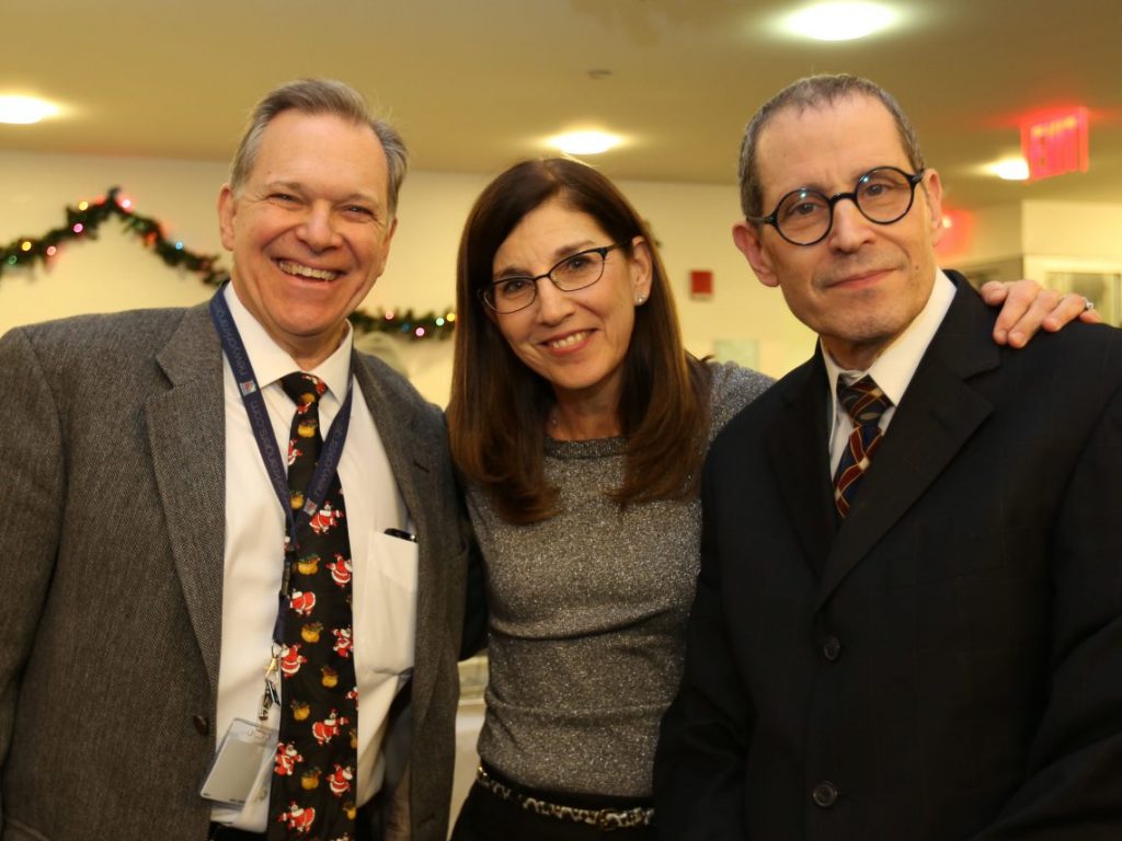 Faculty and staff pose at Optometry Holiday party