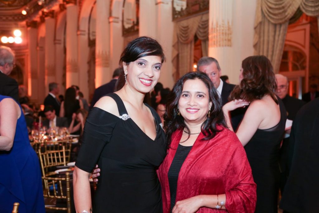 2 women posing for photo at formal event