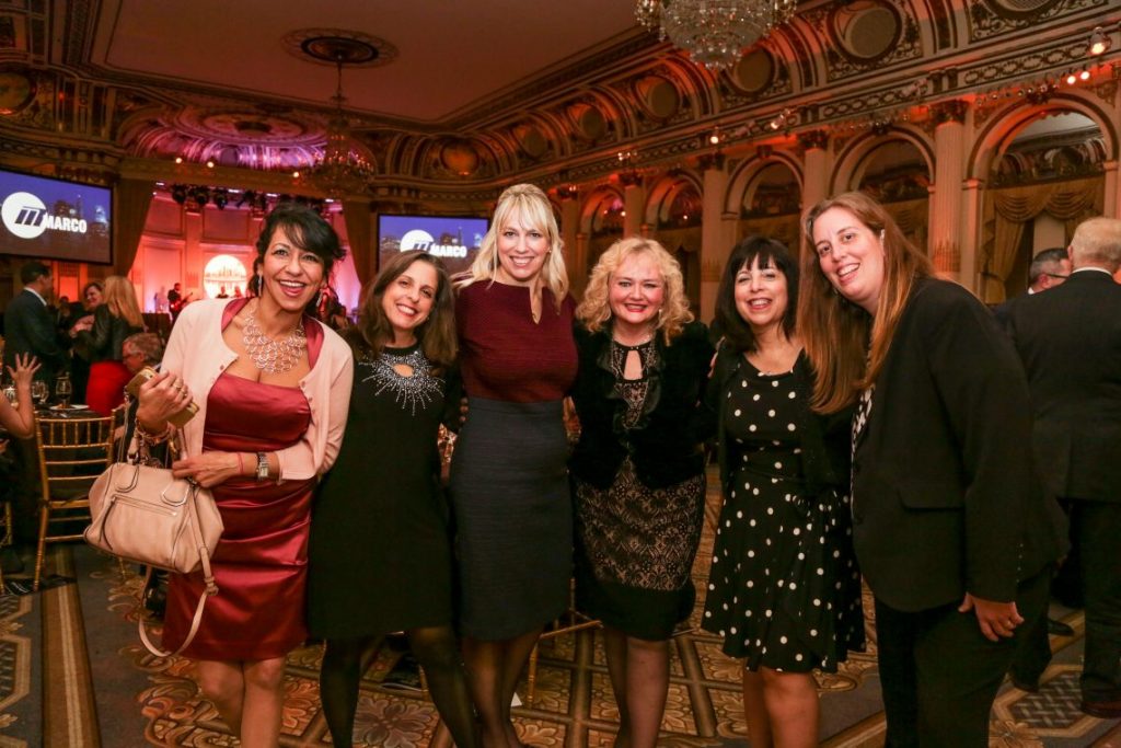 Women posing at photo for formal event