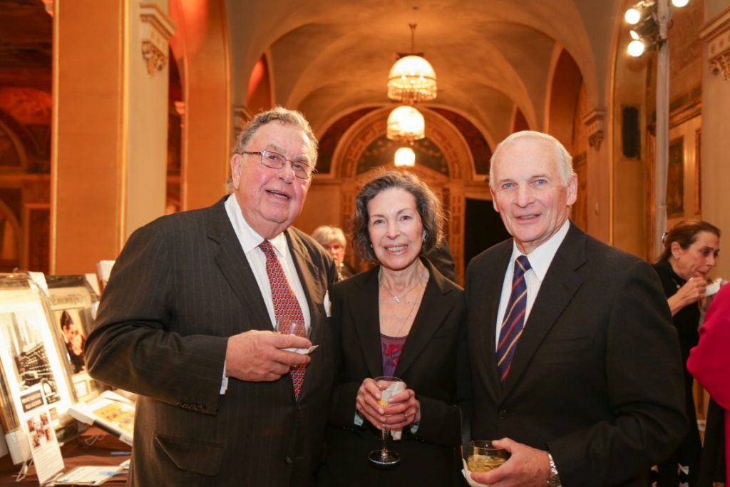 2 men and woman posing for photo at formal event
