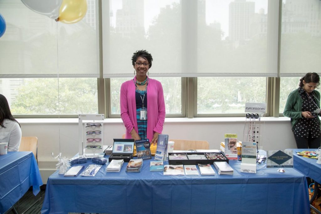 Woman vendor at table with brochures