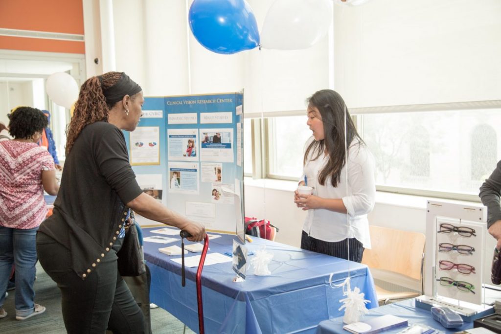 Two women talking at vendor table