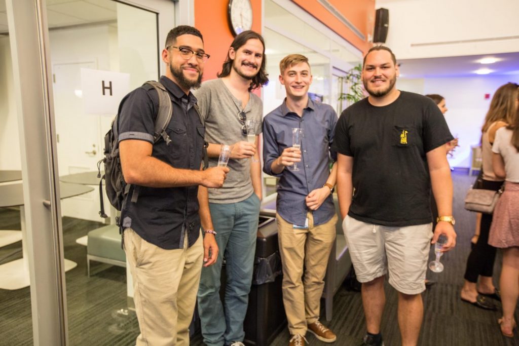 Four members of the Class of 2021 enjoy a champagne toast