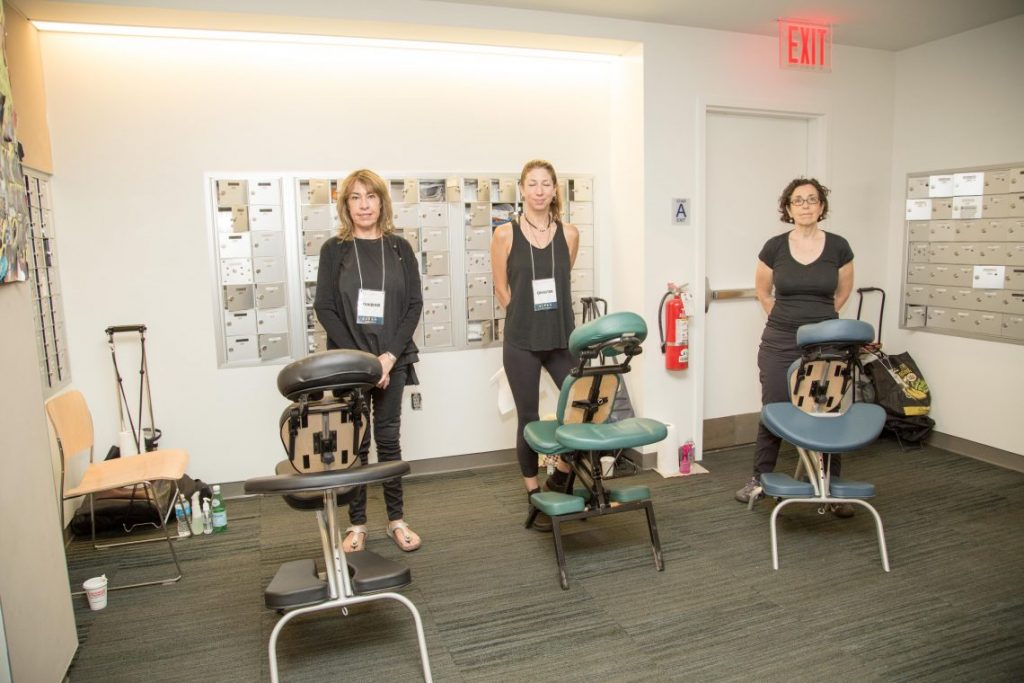 Three women exhibitors with equipment