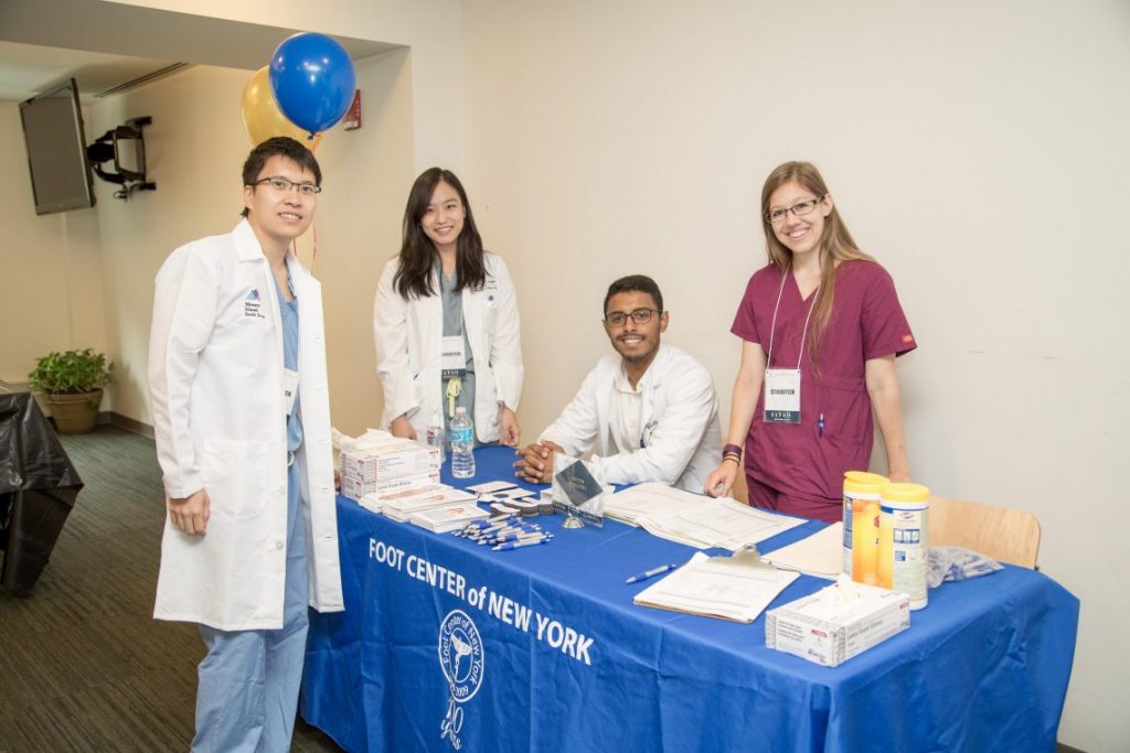 Four doctors at vendor table Foot Center of New York