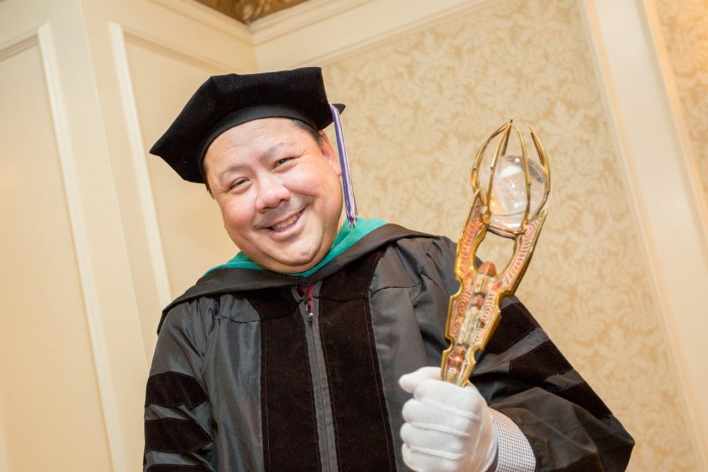 Professor holding award