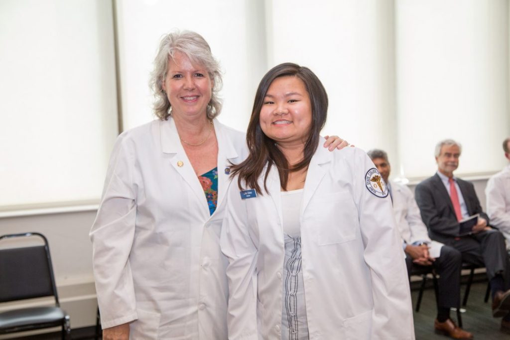 Student receiving white coat
