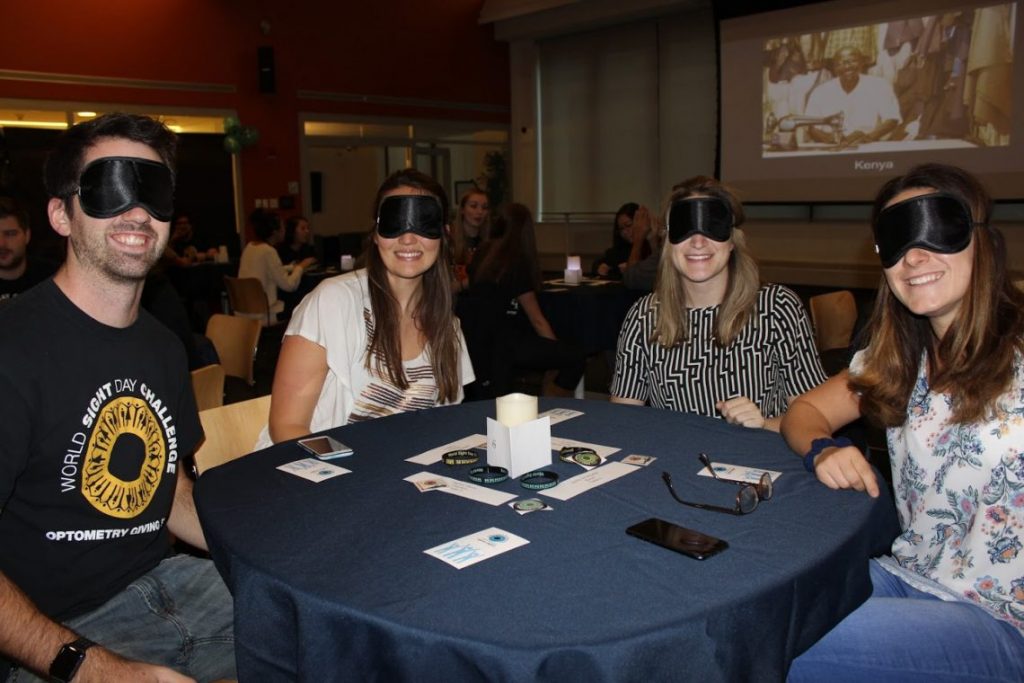 Blindfolded people eating