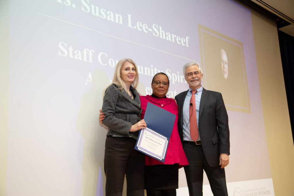 People on stage with award