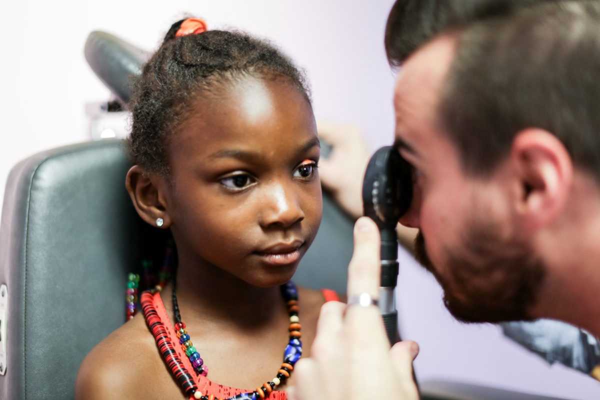 Doctor eye exam on young child